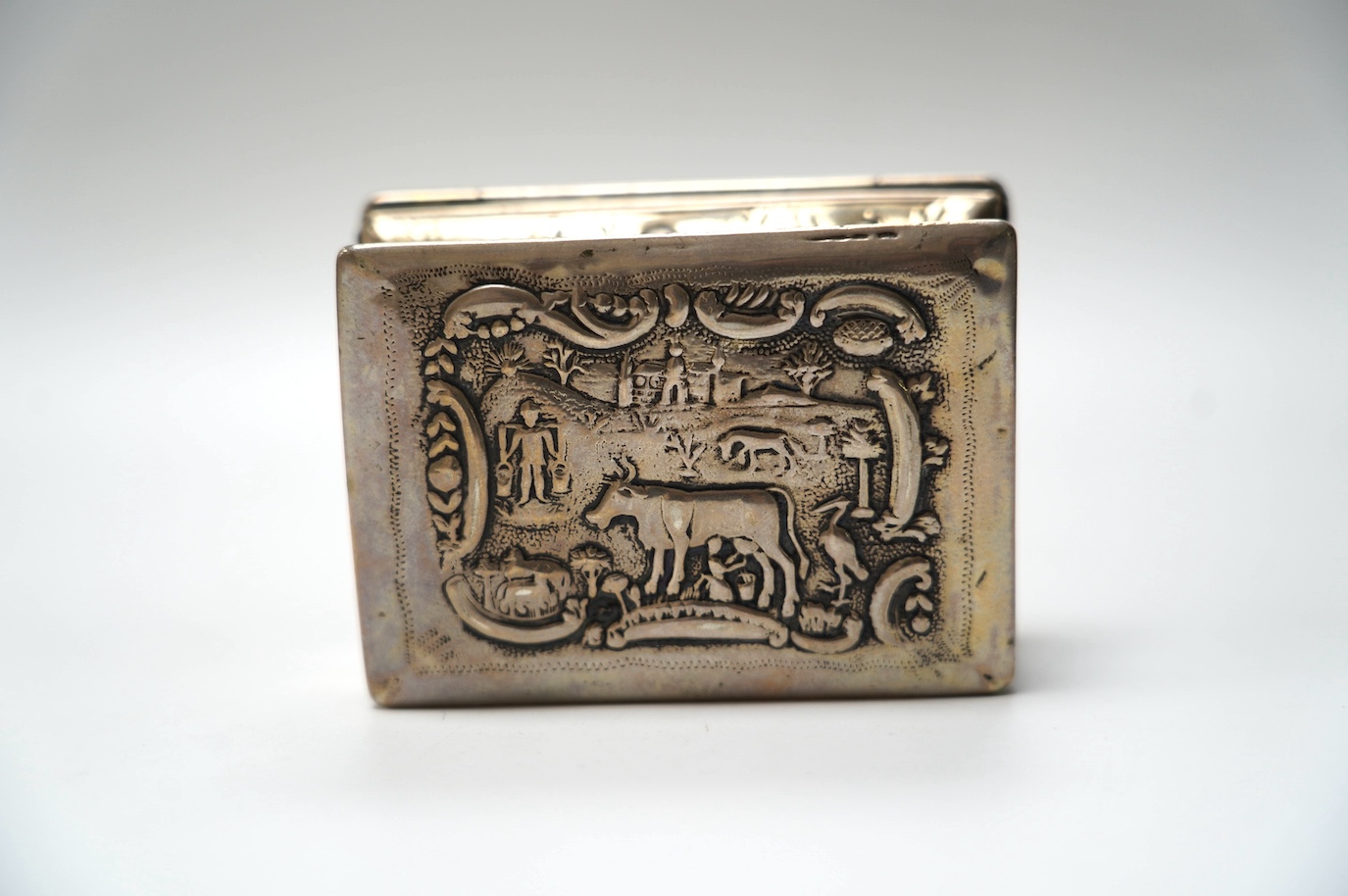 A late 19th century Dutch embossed white metal rectangular snuff box, 83mm, 107 grams. Condition - poor